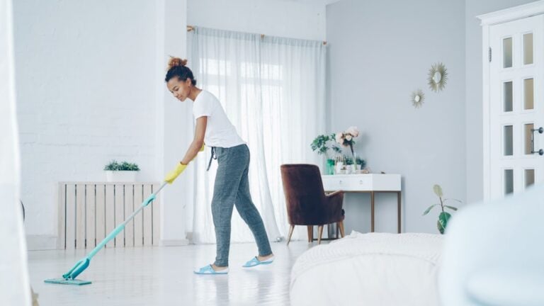 Professional cleaner mopping a modern home floor