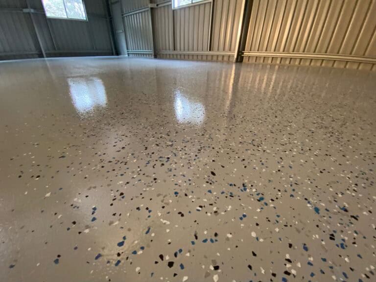 High-gloss epoxy polished concrete flooring in industrial warehouse setting.